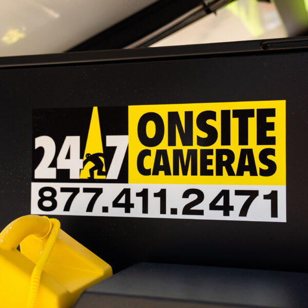 Black box with yellow camera sign.