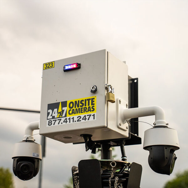 White security box with two dome cameras under cloudy sky.